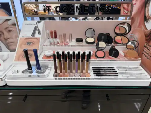 White Acrylic Countertop Display Tray Holding It Cosmetics Makeup Products in a Department Store