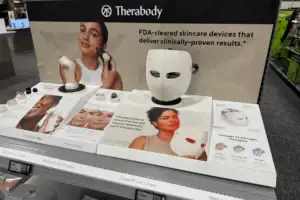 Acrylic Counter Display Presenting Therabody Skincare Devices With Printed Product Graphics