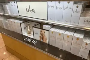 Acrylic Shelf Display With Branded Backers Presenting Dior J’adore Fragrance Packaging
