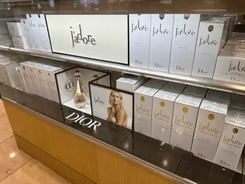 Acrylic Shelf Display With Branded Backers Presenting Dior J’adore Fragrance Packaging