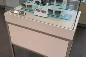 Glass And Acrylic Risers Displaying Designer Sunglasses In An Illuminated Showcase