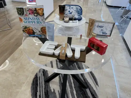 Round Clear Acrylic Table Display With Decorative Letters and Retail Signage
