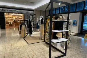 Black Metal Frame Clothing Display Rack With Hanging Apparel And Shelf