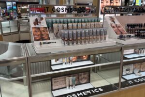 IT Cosmetics Island Counter With Acrylic Product Displays And Lighted Graphics In A Department Store