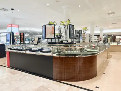 Installed Jewelry Counters With Wood Veneer Bases and Glass Display Tops in a Department Store