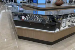 Angled Glass Watch Display Counter With Branded Interior In A Department Store