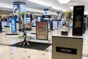 Freestanding Digital Display Towers And Fragrance Fixtures Across A Store Floor