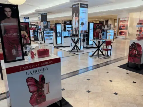 Fragrance Launch Area With Branded Counter Displays and Digital Towers