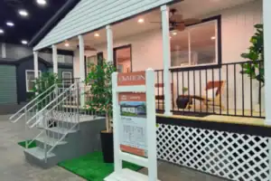 Full-Scale Hybrid Fabrication Project Combining Wood Construction, Metal Railings, and Acrylic Signage to Create an Immersive Branded Structure for a Product Showcase.