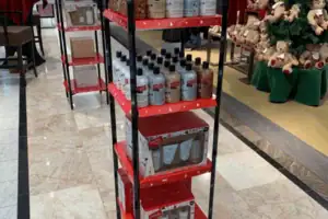 Red Metal Display Tower Merchandising Philosophy Products In A Department Store