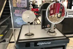 Black Counter Display Presenting Simplehuman Lighted Mirrors In A Department Store