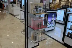 Freestanding Perfume Display Tower With Tiered Acrylic Shelves And Topper Sign