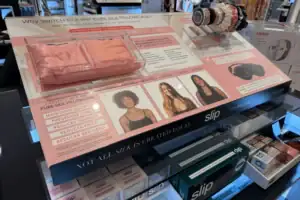 Counter Display With Printed Graphics Presenting Slip Silk Pillowcases And Hair Accessories
