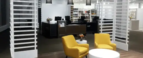 Retail Lounge Area With Modern Seating Beside White Custom Display Towers