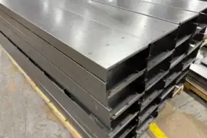 Fabricated Sheet Metal Trays Stacked For Finishing In The Metal Shop