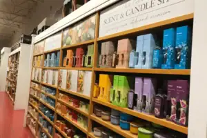 Wood Retail Shelving Aisle With Graphic Headers In A Scent And Candle Shop